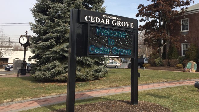 A "Welcome to Cedar Grove" sign.