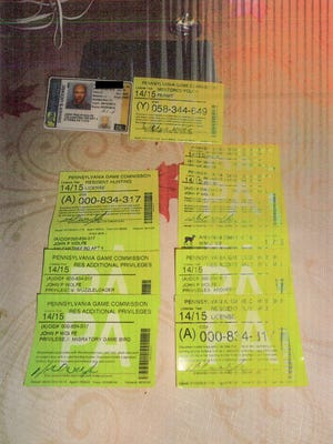 John P. Wolfe used these hunting licenses as exhibits in his defense during an April 2022 trial.