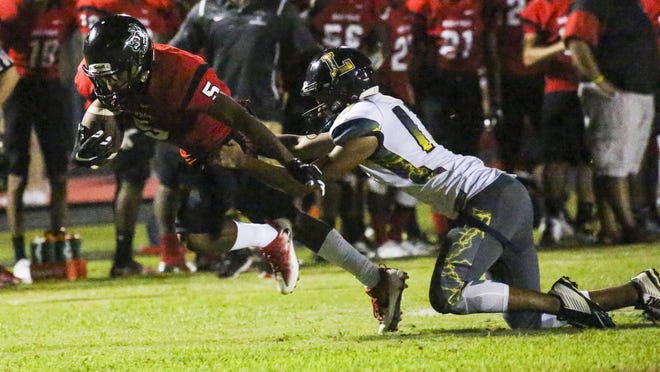 South Fort Myers' Maurice Flournoy gains yards in the second half. Lehigh's Christian Guerra makes the stop. Lehigh played South Fort Myers in their football Friday night.