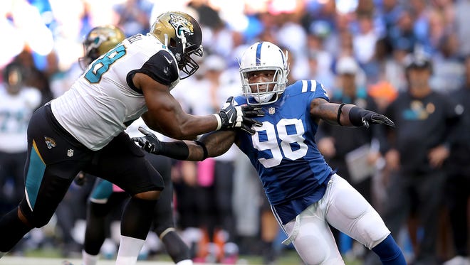 Indianapolis Colts outside linebacker Robert Mathis (98) pass rushes around Jacksonville Jaguars tackle Jermey Parnell.