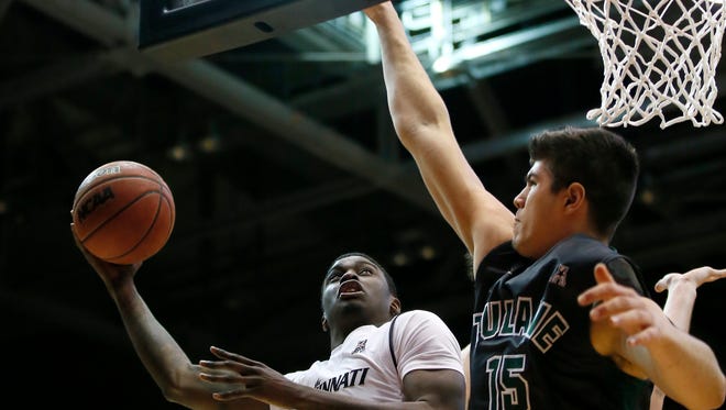 Cincinnati Bearcats forward Shaq Thomas (24) drives to the basket as Tulane Green Wave center Ryan Smith (15) defends in the first half during the NCAA men's basketball game between the Tulane Green Wave and the Cincinnati Bearcats, Sunday, Jan. 24, 2016, at Fifth Third Arena in Cincinnati. 