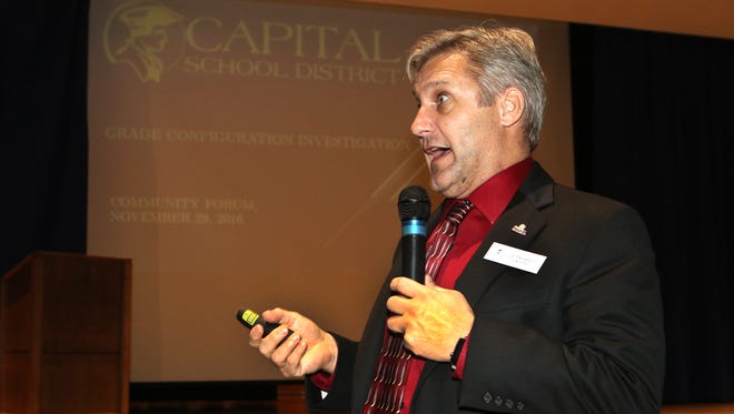 Dan Shelton, superintendent of the Capital School District, explains the format of Tuesday's community forum on class-level reconfiguration, held at William Henry Middle School in Dover.
