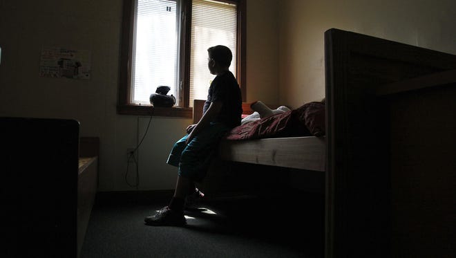 A youth in his room on the Bellewood campus of Uspiritus, a residential center for children in Anchorage.