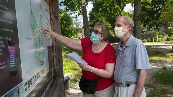 Ellen Miller, left and Wayne Miller, right from Linden Ponds, looks at the map at Worlds End in Hingham on Thursday June 4, 2020. The Millers were locked in their apartment for nearly three months. Photo by Lauren Owens Lambert / for The Patriot Ledger.