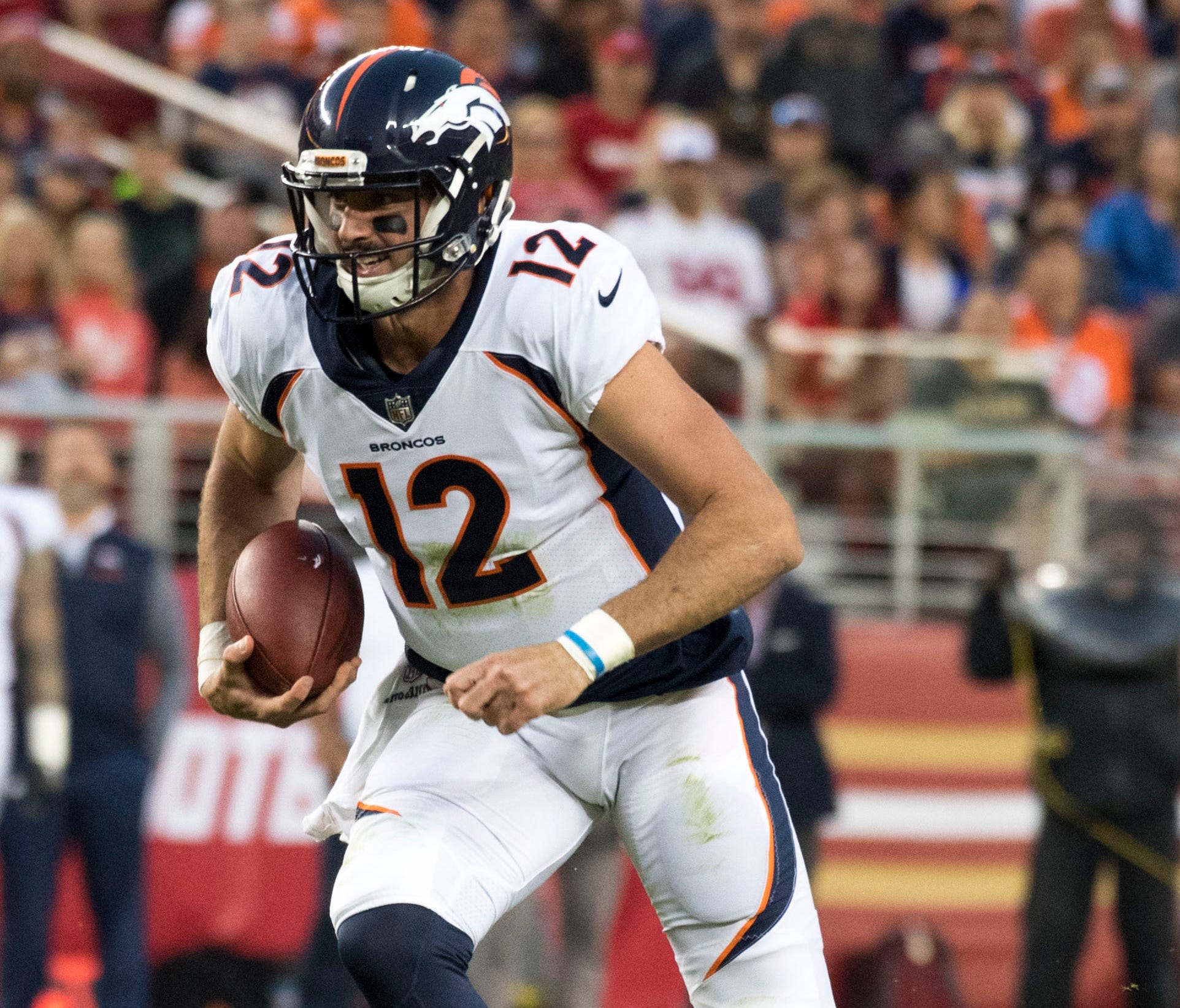 Denver Broncos quarterback Paxton Lynch (12) runs with the football against the San Francisco 49ers during the second quarter at Levi's Stadium.