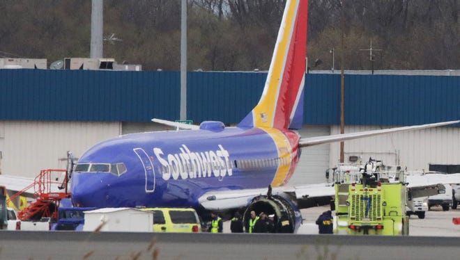 A Southwest Airlines jet sits on the runway at Philadelphia International Airport after it was forced to land with an engine failure, in Philadelphia, Pennsylvania, on April 17, 2018.