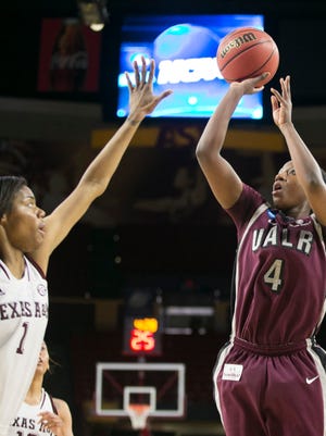 UALR guard Kiera Clark puts up a shot as Texas A&M forward Courtney Williams defends during the first half of the first round game of the NCAA Division I Women's Basketball Championship tournament at Wells Fargo Arena in Tempe on March 21, 2015.