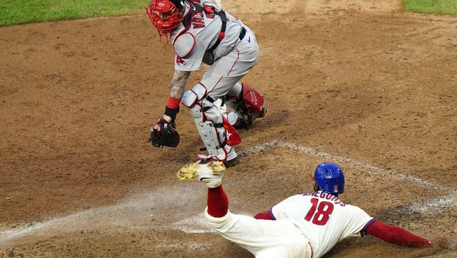Phillies shortstop Didi Gregorius (bottom) scores the the game-winning run past Red Sox catcher Christian Vazquez on a two-run single by Alec Bohm off pitcher Matt Barnes during the seventh inning of the first game of a doubleheader on Tuesday, Sept. 8, 2020, in Philadelphia.