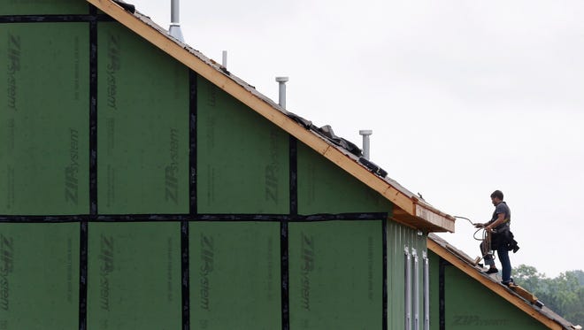 A roofer works on a home under construction in Chapel Hill, N.C.