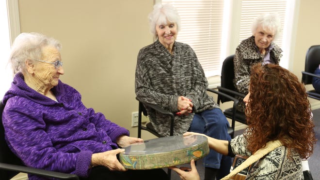 Music therapist Jessica Western works with Rosalie Kilgore, left, Dona Vandersanden and Joyce Manahan during a program called Art & Music, which helps Alzheimer's and dementia patients improve their quality of life, Thursday, Dec. 10, 2015, at the AlzheimerÕs Network in Salem, Ore.           