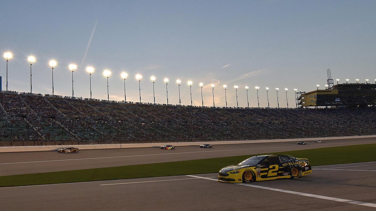 Monster Energy NASCAR Cup Series driver Brad Keselowski (2) pulls out of the pits as the sun sets during the KC Masterpiece 400 on May 12, 2018, at the Kansas Speedway in Kansas City, KS.