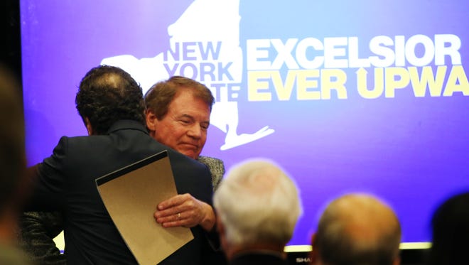 Danny Wegman hugs Governor Andrew Cuomo before Cuomo took the stage for his State of the State tour stop in Rochester.