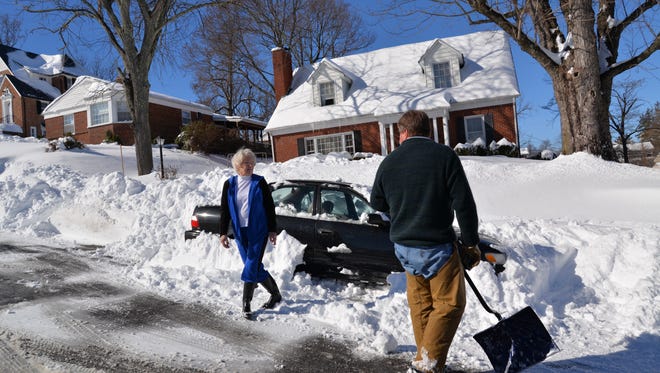 David Cupp digs out his mother Mary Lee Akers on Walnut Avenue in Waynesboro along with friends on Sunday, Jan. 24, 2016.