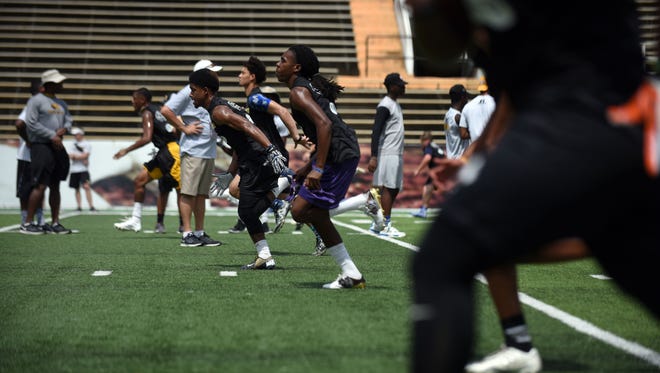 High school and junior college football prospects run sprints Friday at the Southern Miss Elite Camp at M.M. Roberts Stadium.