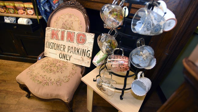 An old customer parking sign for King Hardware and Gifts sets on a chair in the newly renovated gourmet coffee section of the store.