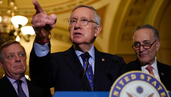 Senator Harry Reid of Nev., flanked by Senator Richard Durbin of Ill., left, and Senator Charles Schumer of N.Y., opened the door for Republicans today when he changed Senate rules to benefit Democrats in 2015. (AP Photo/Sait Serkan Gurbuz)