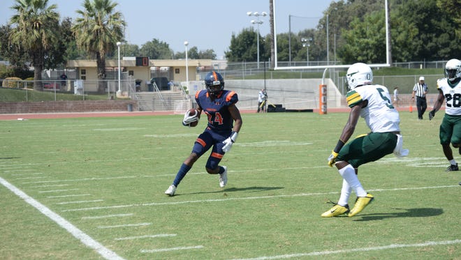 COS WR Juwan McCall looks to avoid a defender in a game earlier this year.