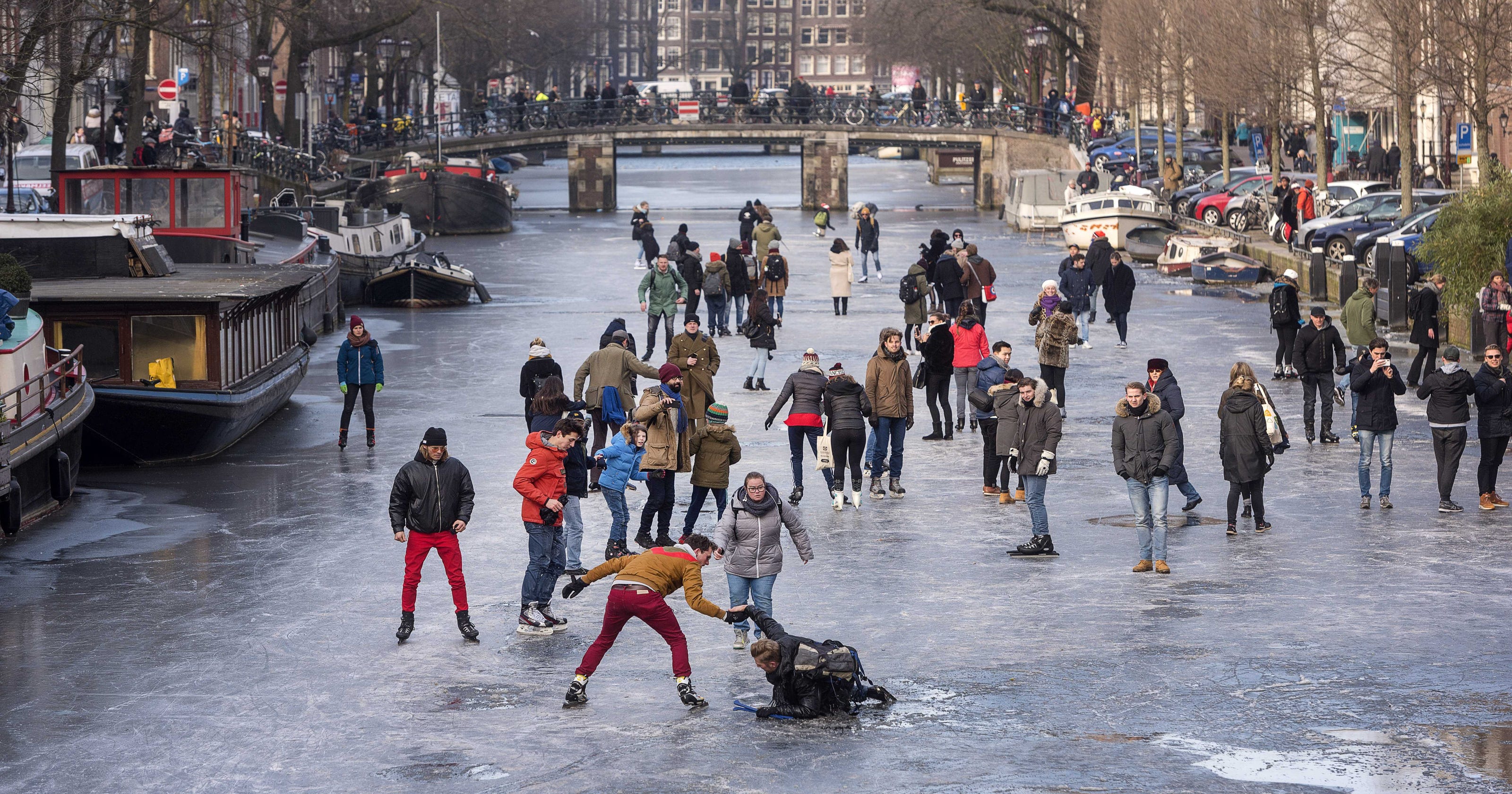 Europe weather: Amsterdam's canals freeze over; ice skaters flock holland weather in may