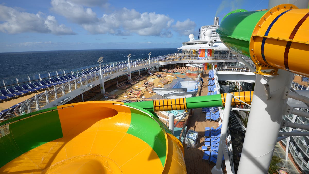 The Perfect Storm water slide area on Symphony of the Seas includes a yellow-and-green 'champagne bowl' slide.