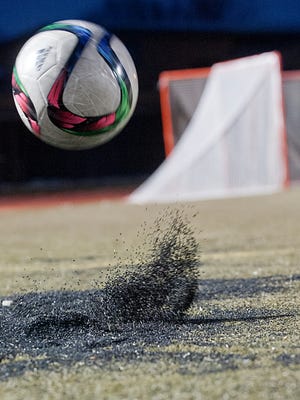 Photo illustration of rubber particles being kicked up at the St.Xavier High School soccer field. The Kentucky Players Academy was practicing there.16 February, 2016
