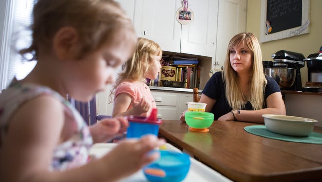 Christina Foster sits with her daughters, Avery, 1, and Sadie, 3, as they enjoy an afternoon snack. Christina realized there were no programs in Rochester to help with buying diapers when she and her husband had their first daughter, Sadie, and were looking for help for themselves.