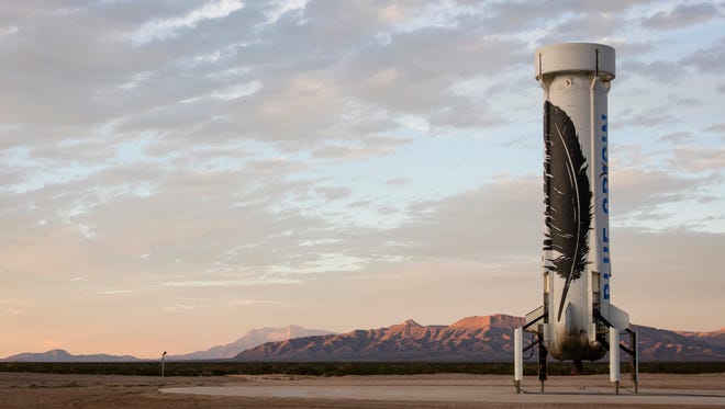 In this photo provided by Blue Origin taken on Monday, Nov. 23, 2015, an unmanned Blue Origin booster rocket sits after landing in Van Horn, West Texas.