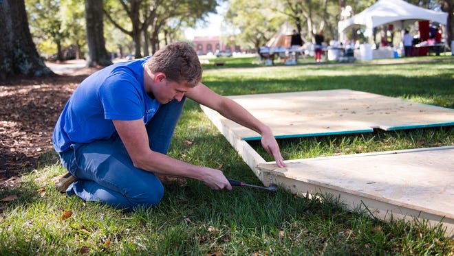 Furman Beta Theta Pi student Henry London works on a float as he and his fraternity brothers prepare for homecoming at Furman University on Thursday, Oct. 19, 2017.