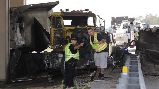 A semi truck involved in a crash on i75 is visible underneath the Estero Parkway overpass.