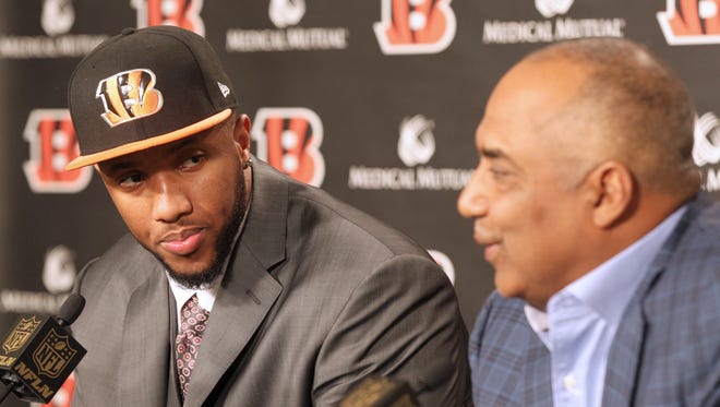 Cedric Ogbuehi listens as Bengals head coach Marvin Lewis speaks on Friday during his introduction to the city.