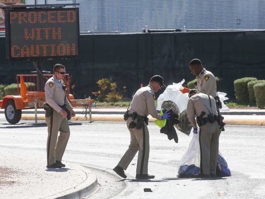 Police gather the personal effects of people who fled