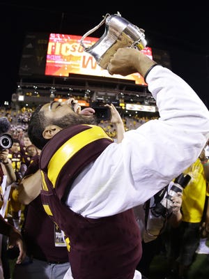 Arizona State quarterback Manny Wilkins celebrates with the Territorial Cup after defeating Arizona on Nov. 25, 2017 during the 91st Annual Territorial Cup in Tempe, Ariz.