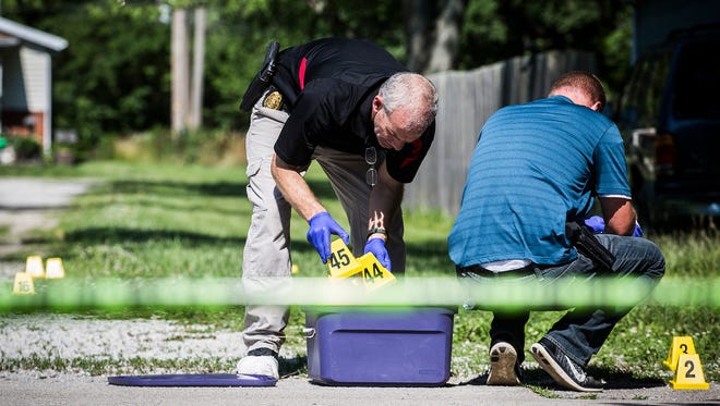 Investigators at the scene of a police-involved shooting in the 3600 block of North Franklin Street in June 2018. Delaware County Prosecutor Eric Hoffman later said city police officers had been justified in firing gunshots at Gary Mort, who refused to drop what turned out to be a pellet gun. Mort this week was placed on probation after pleading guilty to setting his house on fire before being shot.