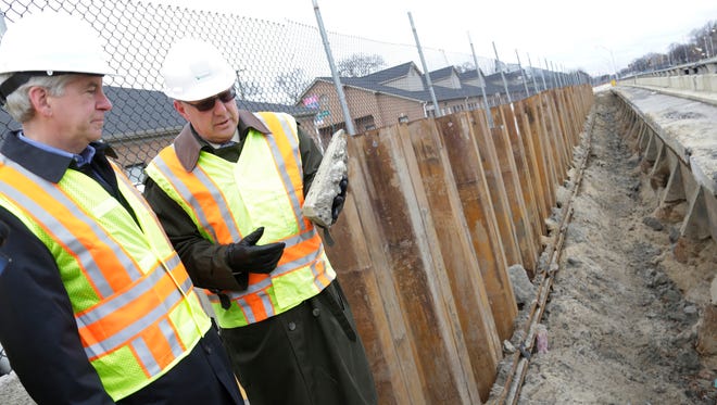 Governor Rick Snyder, left, is joined at the Lodge freeway  by Michigan Department of Transportation Director Kirk Steudle Monday Dec. 1, 2014 in Detroit as they discuss the amount of work that is needed to help fix Michigan roads.