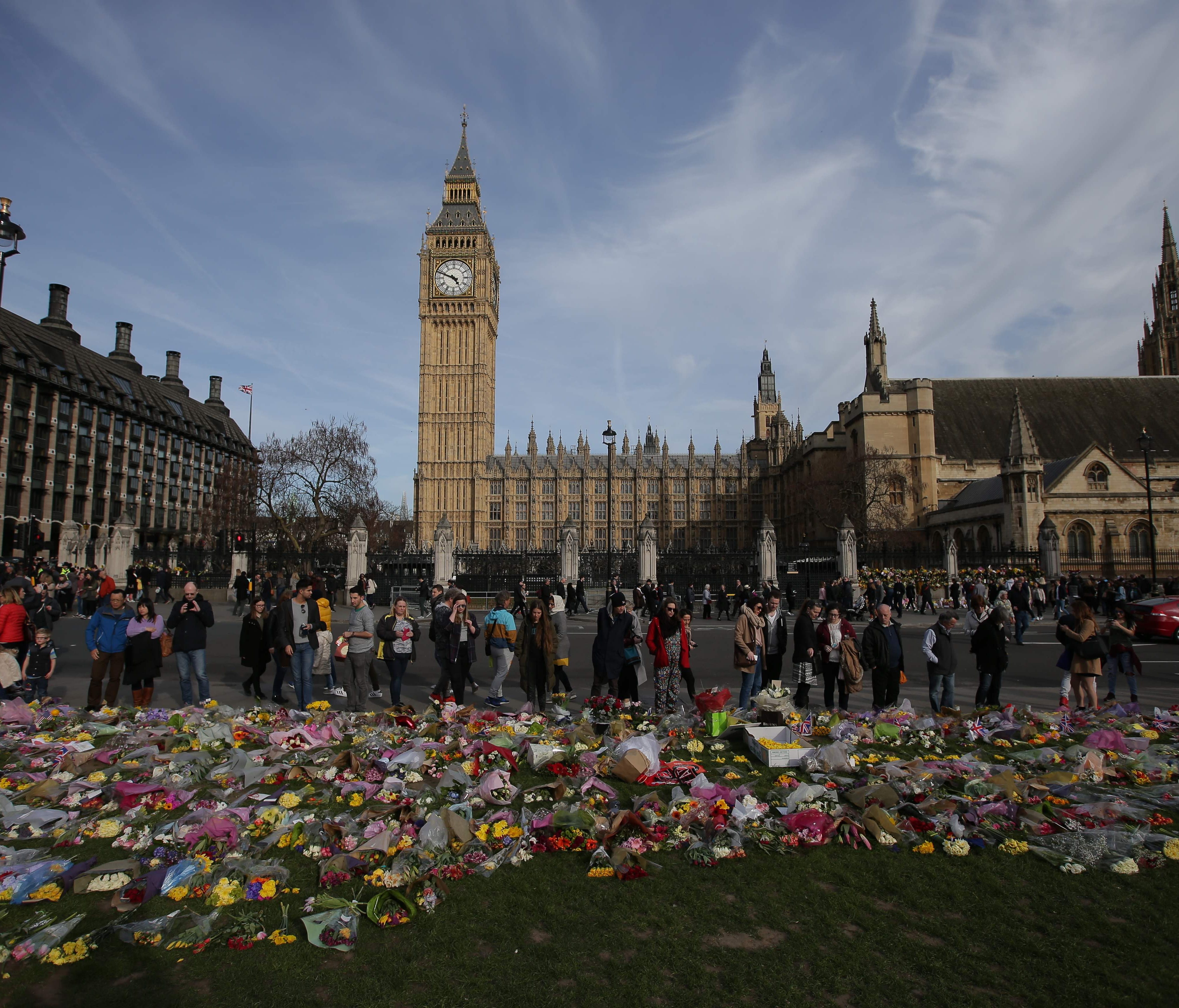 Floral tributes to the victims of the March 22 terror attack are seen in Parliament Square in central London on March 26, 2017.  British police investigating the terror attack on parliament made a new arrest on March 26 as authorities try to piece tog