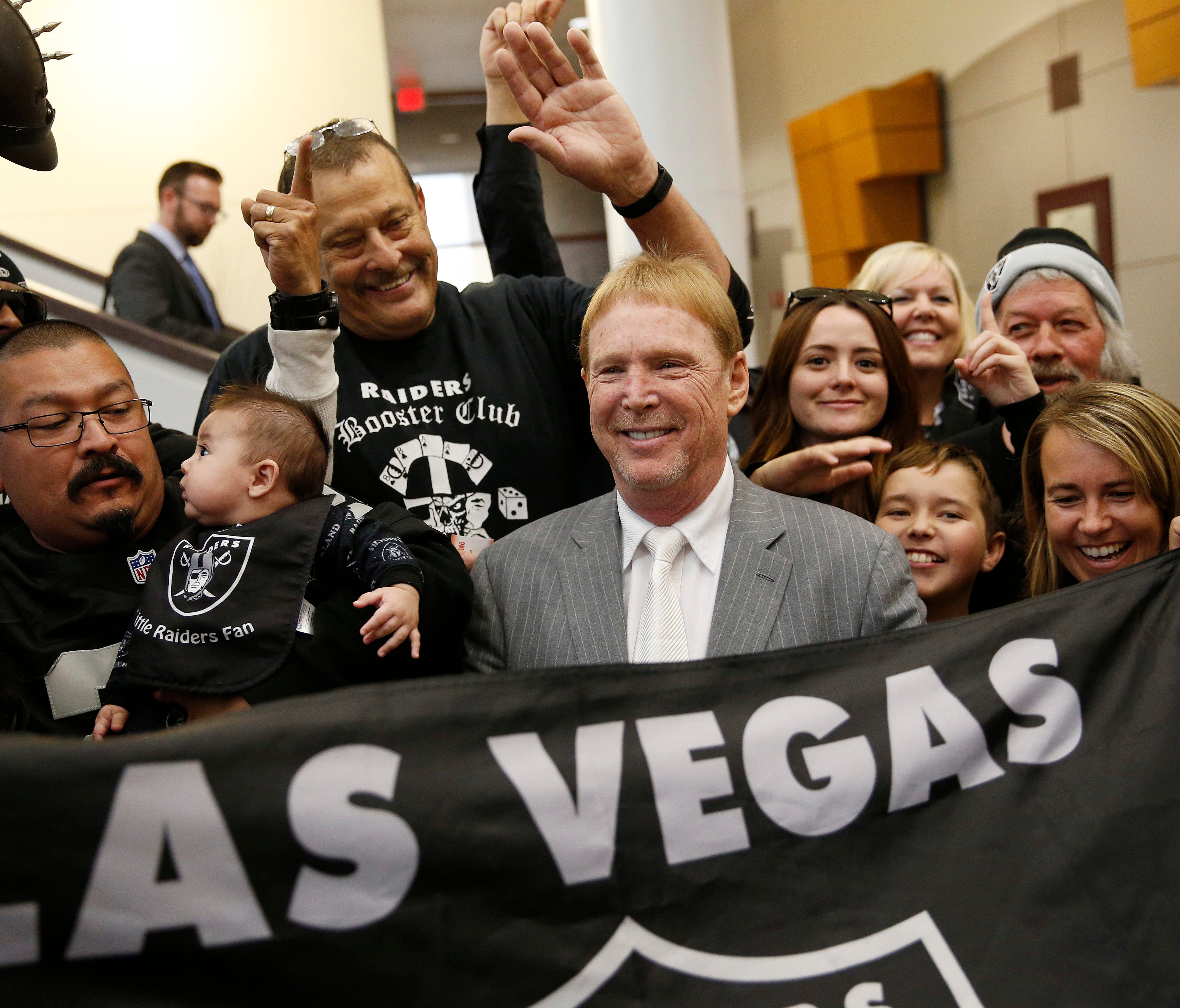 Oakland Raiders owner Mark Davis, center, is moving his team to Las Vegas where he can generate more local revenue.