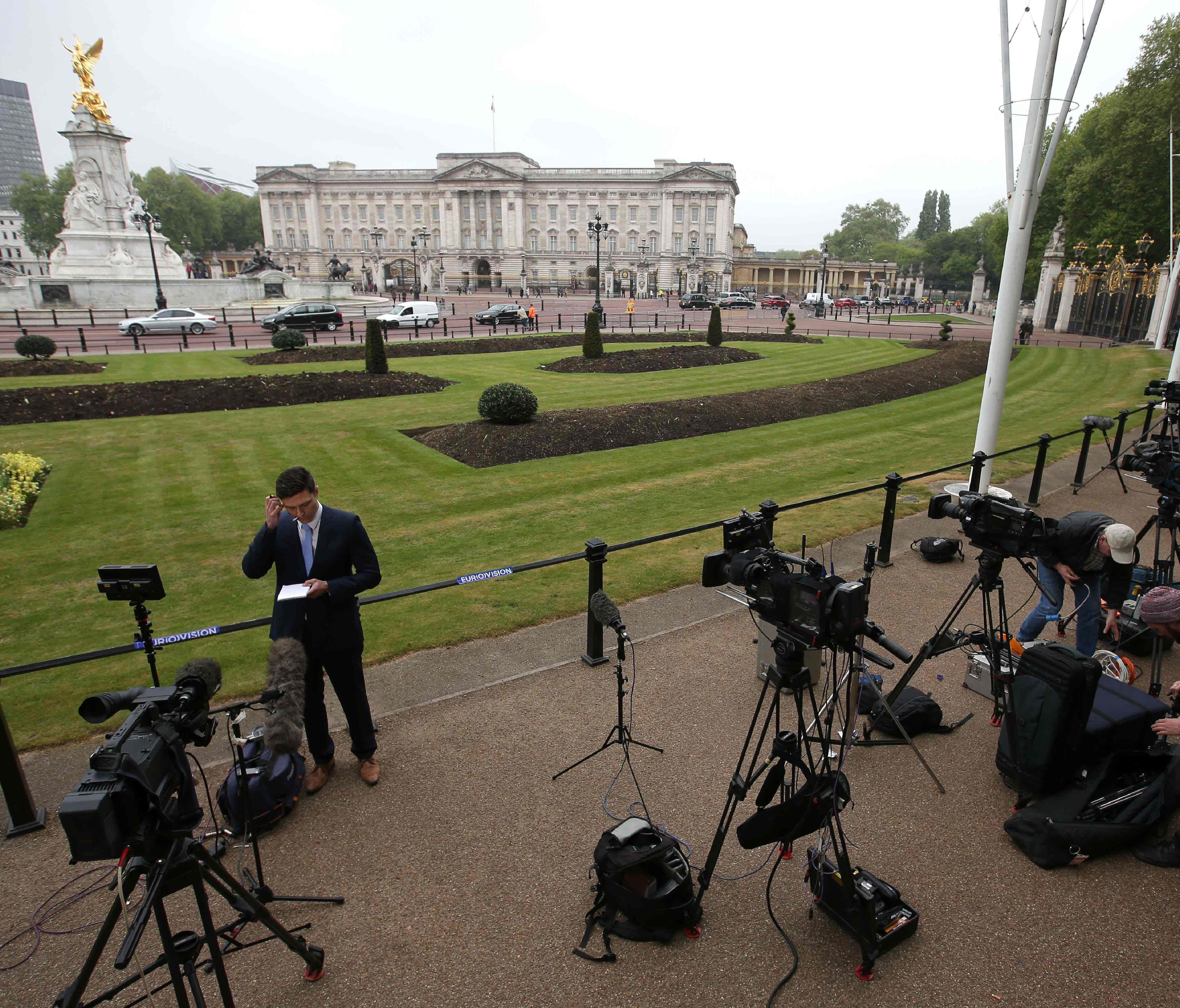 Television crews stand outside Buckingham Palace after after Queen Elizabeth II's staff were called there for an 