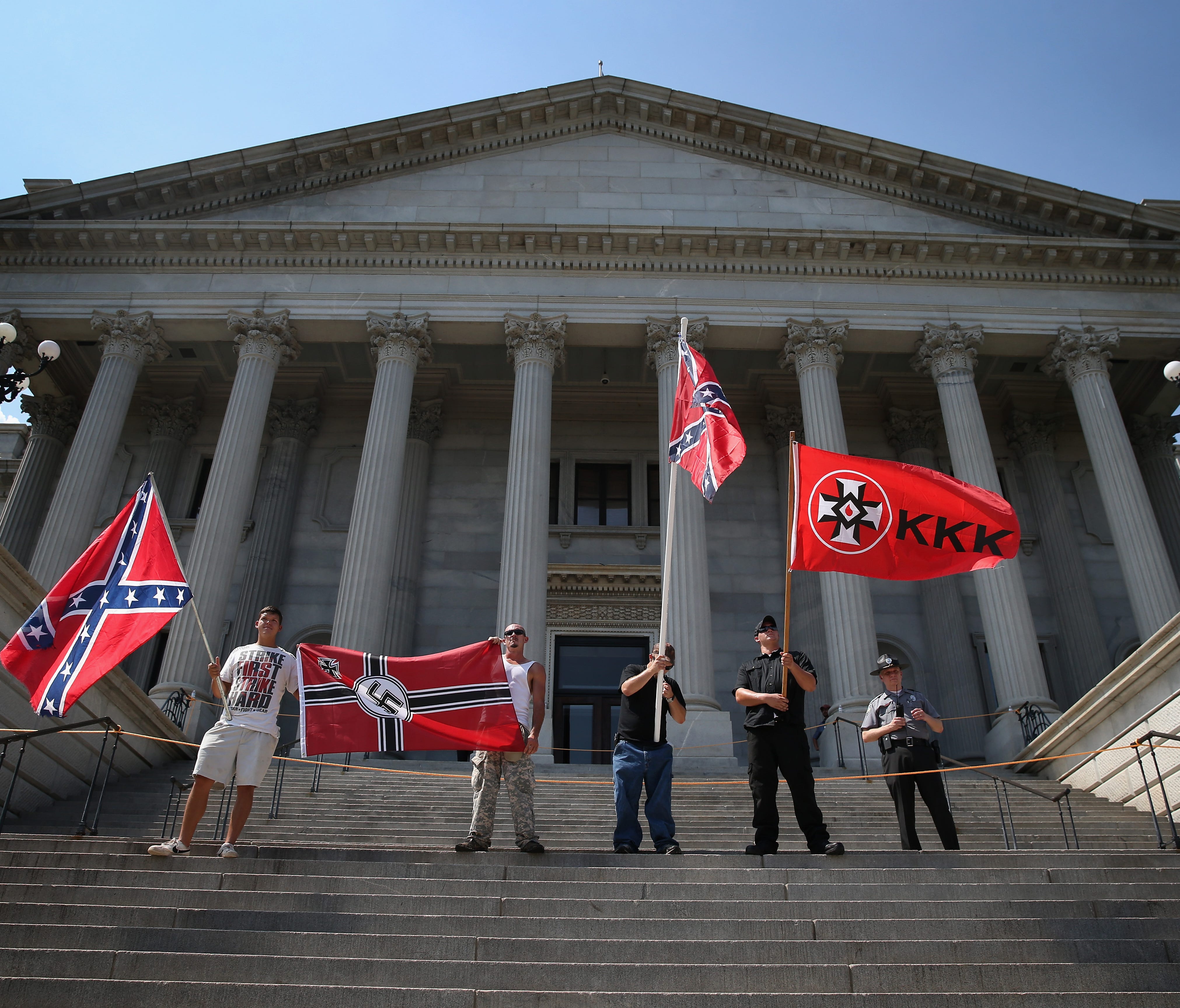 Ku Klux Klan members take part in a demonstration at the South Carolina state house on July 18, 2015, in Columbia, S.C.