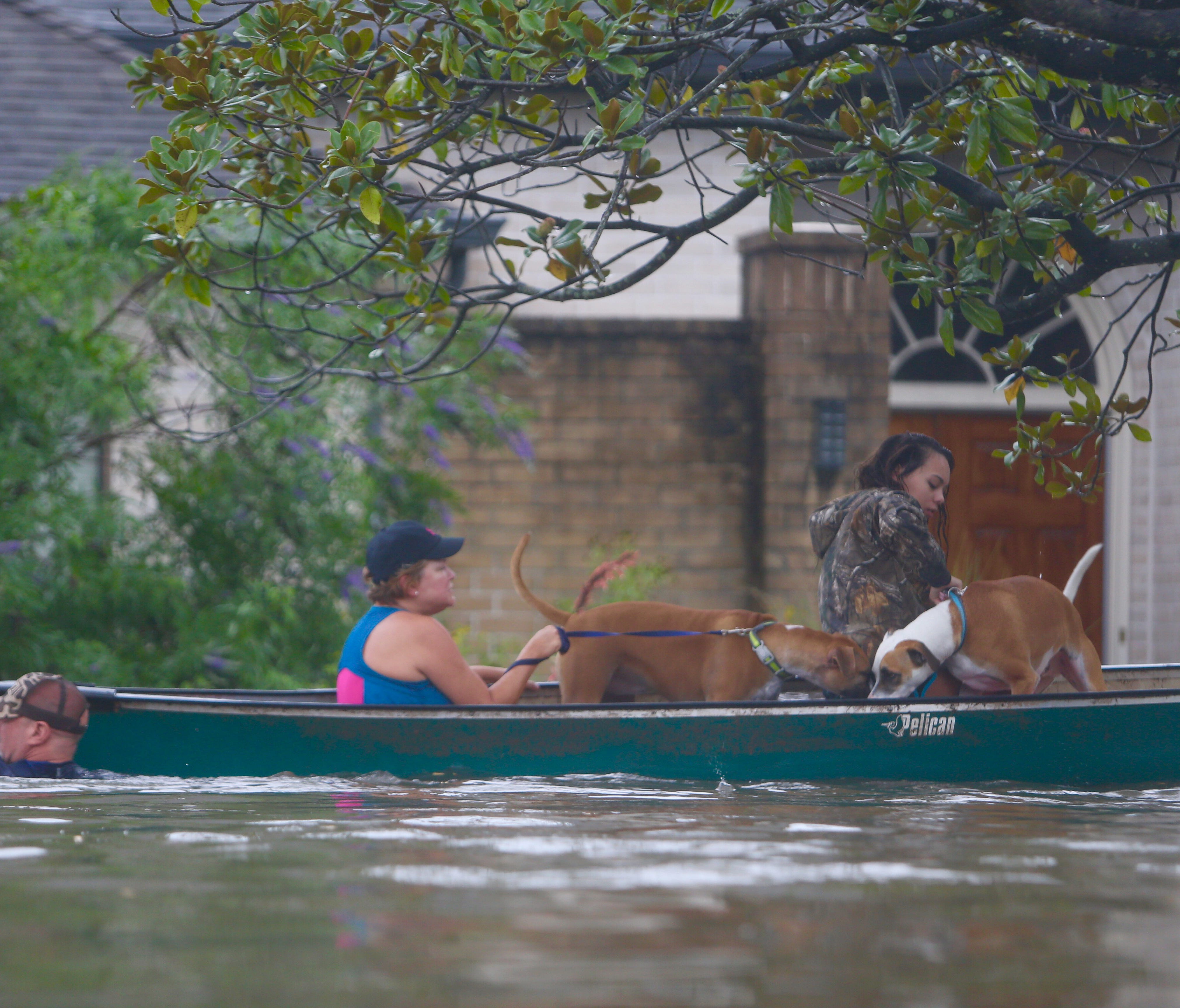 A family evacuates their Meyerland home in Houston on Aug. 27, 2017, amid rising floodwaters.