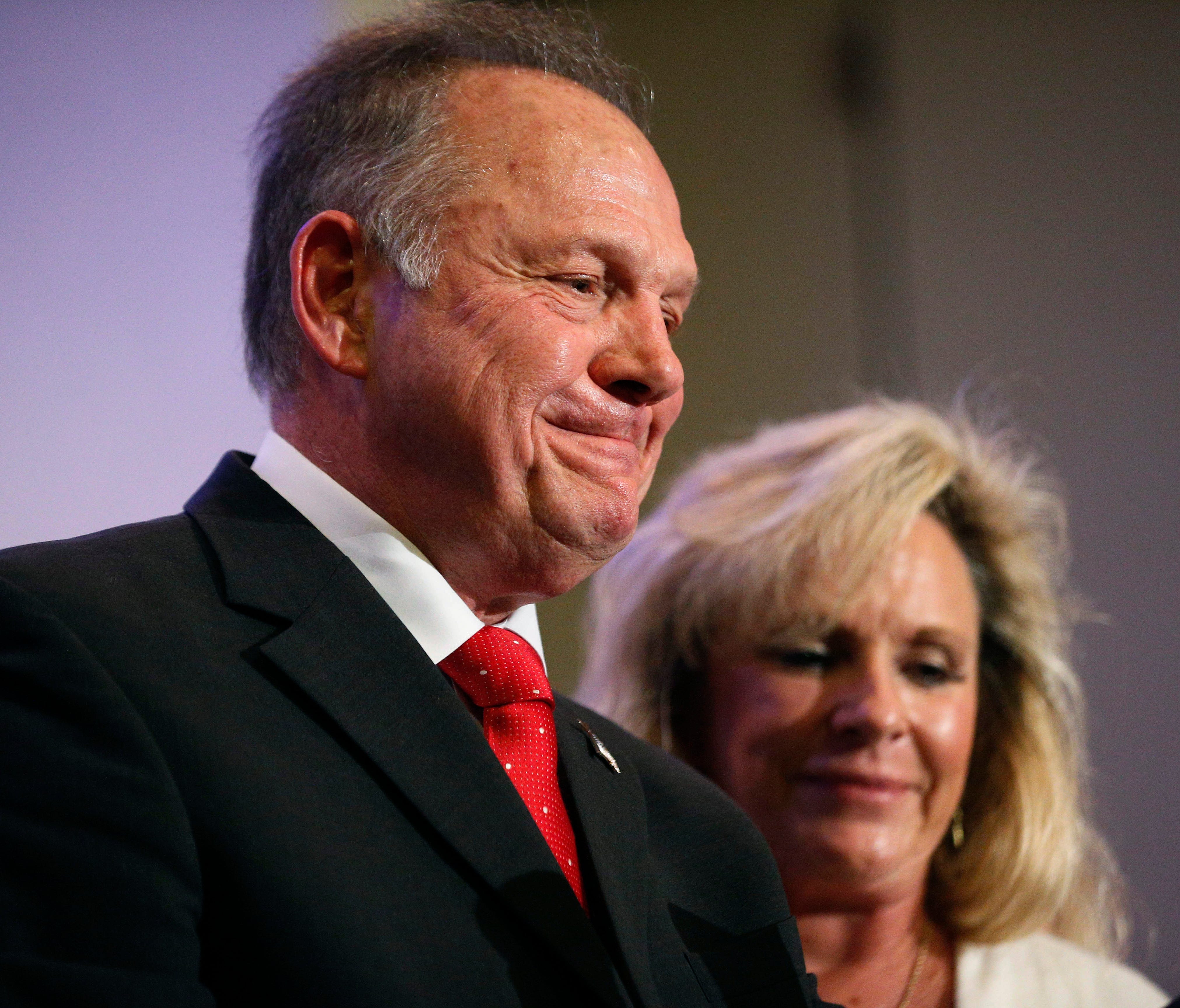 U.S. Senate candidate Roy Moore is pictured speaking at a news conference in Birmingham, Ala., with his wife Kayla Moore.