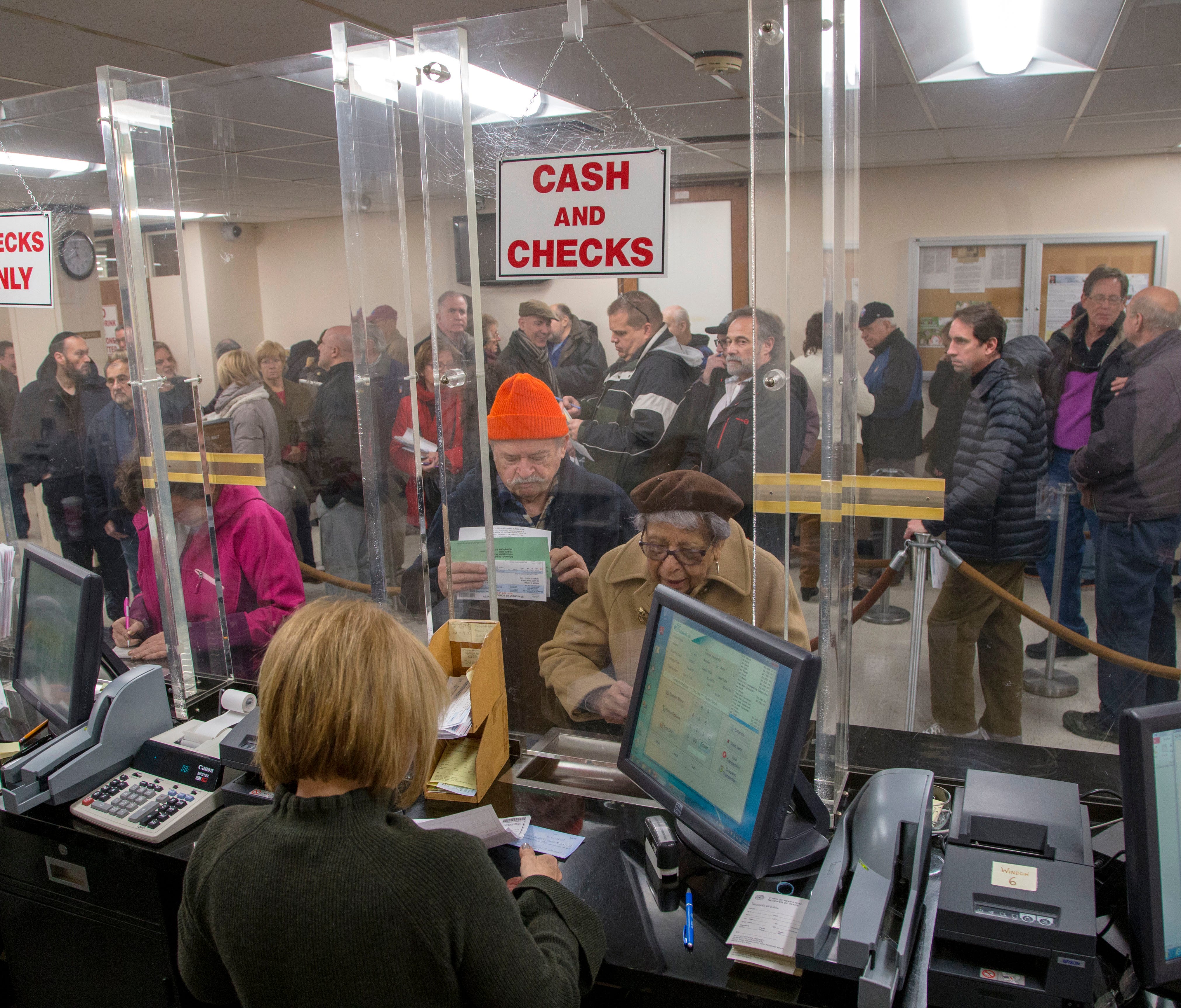 This Dec. 26, 2017, photo shows people lined up in the Hempstead, N.Y. tax receiver's office to pre-pay their property taxes eir real estate taxes before the end of the 2017, hoping for one last chance to take advantage of a major tax deduction befor