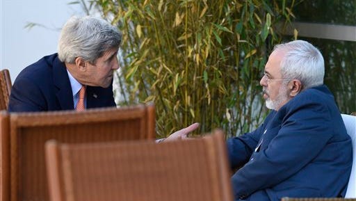 U.S. Secretary of State John Kerry, left, talks with Iranian Foreign Minister Mohammad Javad Zarif, in Geneva, Switzerland, Saturday, May 30, 2015.  Top U.S. and Iranian diplomats are gathering in Geneva this weekend, hoping to bridge differences over a nuclear inspection accord and economic sanctions on Tehran. (AP Photo/Susan Walsh, Pool)