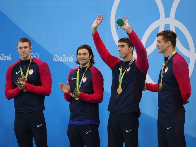 Michael Phelps and teammates celebrate on the podium