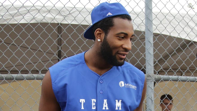 Detroit Pistons center Andre Drummond chats during the Lions' annual charity softball game in Dearborn on June 5, 2015.