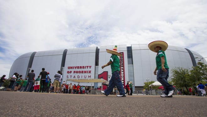 Fans of Mexico wait to enter University of Phoenix Stadium for a CONCACAF Gold Cup Group C doubleheader soccer match in Glendale July 12, 2015.