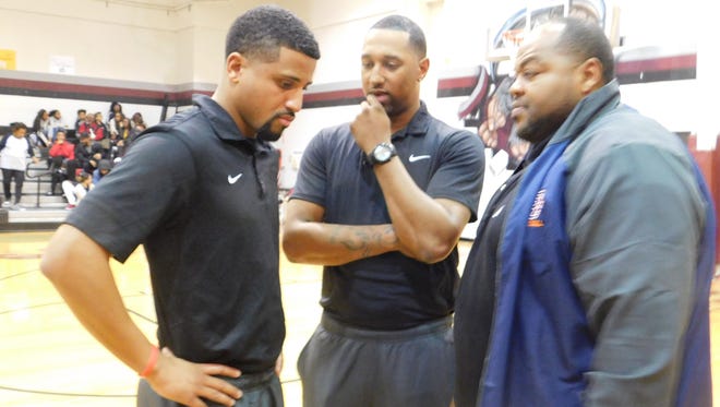 Chris Charlot and his Beau Chene boys' coaching staff discuss strategy at the Northwest High tournament.