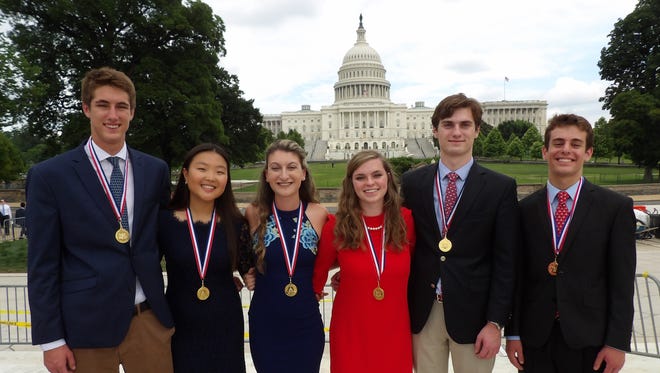 Congressional Gold Medal recipients Matthew Ewoldt of Jupiter, left, Nathalie Han of Miami, Gina Carvelli of Port St. Lucie, Victoria Potter of Charleston, W.V., Jack Goetschius of Palm Beach Gardens, and Nolan Fitzsimmons of Falls Church, Va., stand in front of the U.S. Capitol.