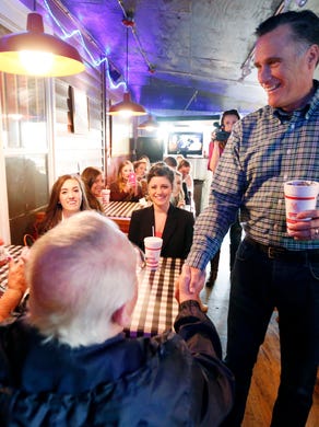Mitt Romney visits with diners at Little Dooey, a barbecue restaurant in Starkville, Miss., on Jan. 28.
