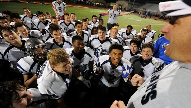 "We made history!" says Dallastown head coach Kevin Myers as his team celebrates their 33-14 victory over Central York on Friday, Oct. 30, 2015. 