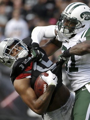 Oakland Raiders wide receiver Michael Crabtree, left, is tackled by New York Jets cornerback Antonio Cromartie (31) during the first half of a Nov. 1, 2015, game in Oakland, Calif. New York cut Cromartie in February in a cost-cutting move, saving $8 million on the salary cap.