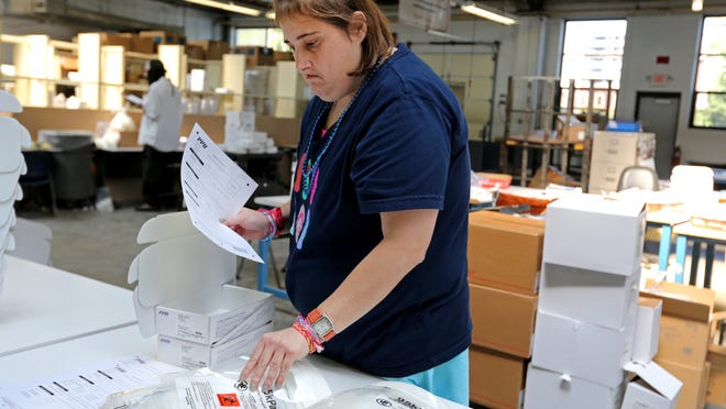  Kelly Kroth, left, and Yolanda Harlow, right,  work at Easter Seals Packaging and Logistics Enterprises in Walnut Hills.  Easter Seals employs developmentally disabled people .